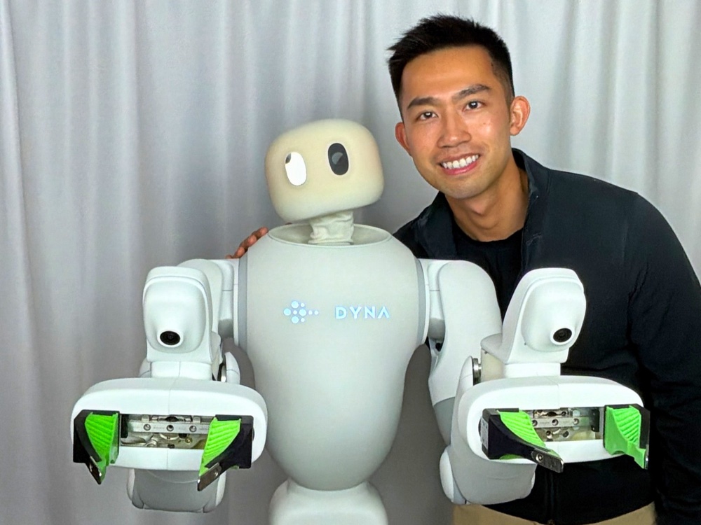 Jason Ma with Dyna's robot Taku